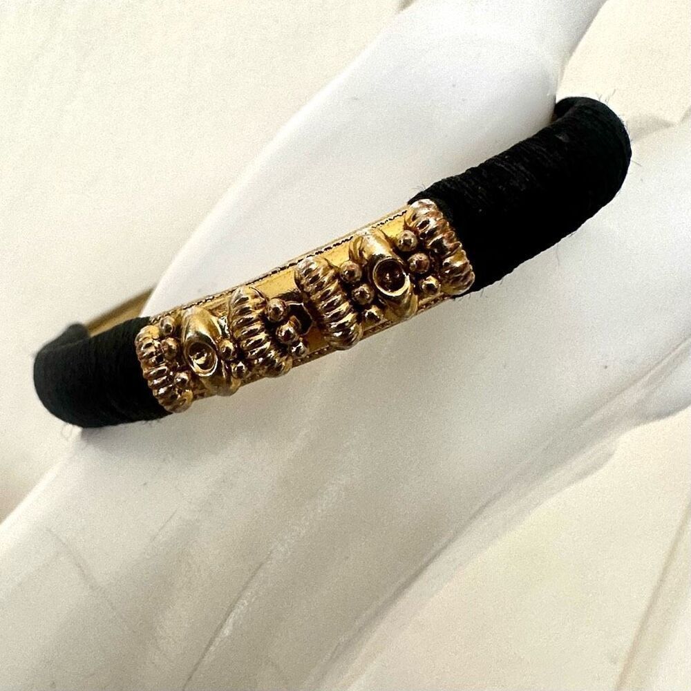 Black threaded gold tone bangle bracelet